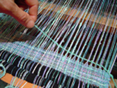 Detail of weft yarn pulled through a loom